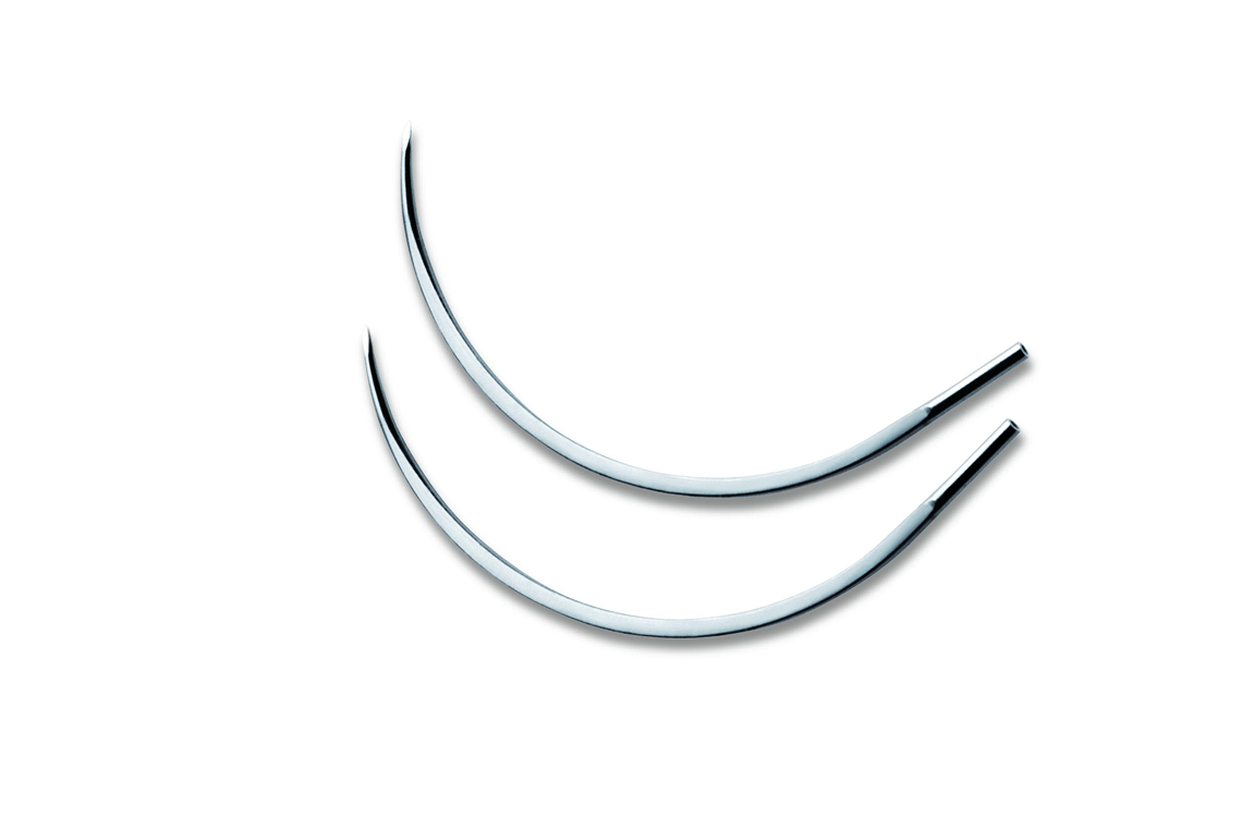 Two curved surgical needles placed on a white background