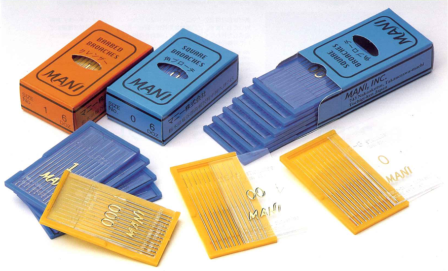 Packaging and trays of MANI barbed broaches and square broaches for dental use, displayed in orange and blue boxes with clear trays containing fine metal instruments